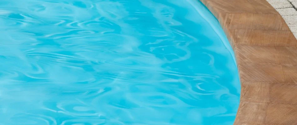 Clean pool with brown coping in Bridgehampton, NY.