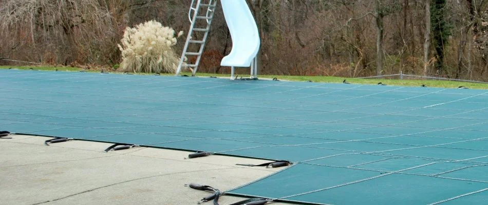 Covered pool in Bridgehampton, NY, with a slide.