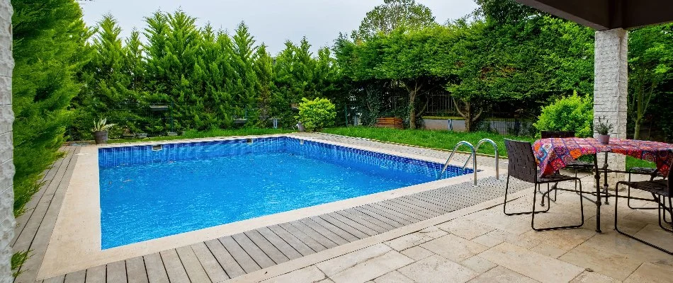 Dense hedges around a rectangular pool in Bridgehampton, NY.