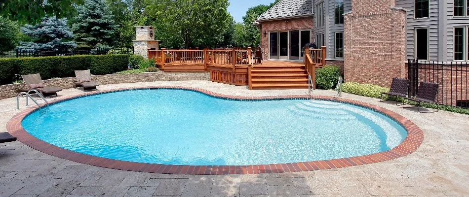 Outdoor space of a house in Bridgehampton, NY, with a kidney-shaped pool.