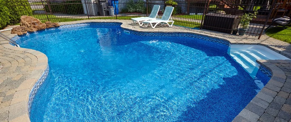 Lounge chairs by a pool in Bridgehampton, NY.
