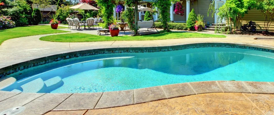 Outdoor living space in Bridgehampton, NY, with pool and landscaping.
