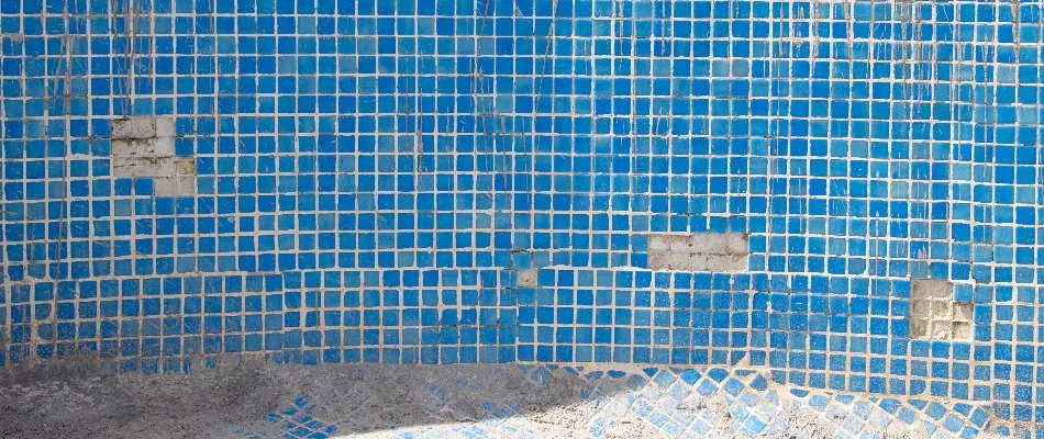 Pool in Bridgehampton, NY, with damaged tiles.