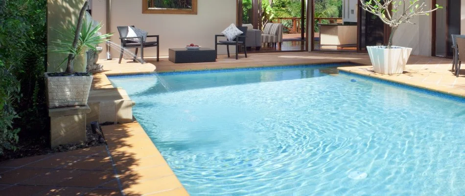 Pool in Bridgehampton, NY, with a water feature.
