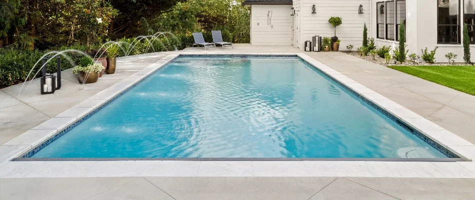 Rectangular pool in Bridgehampton, NY, with a water feature.