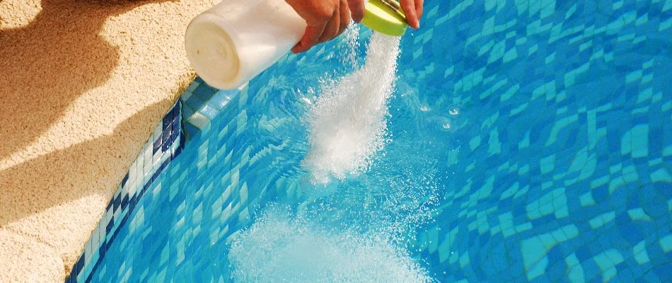 Treating a pool in Bridgehampton, NY, with chemicals.