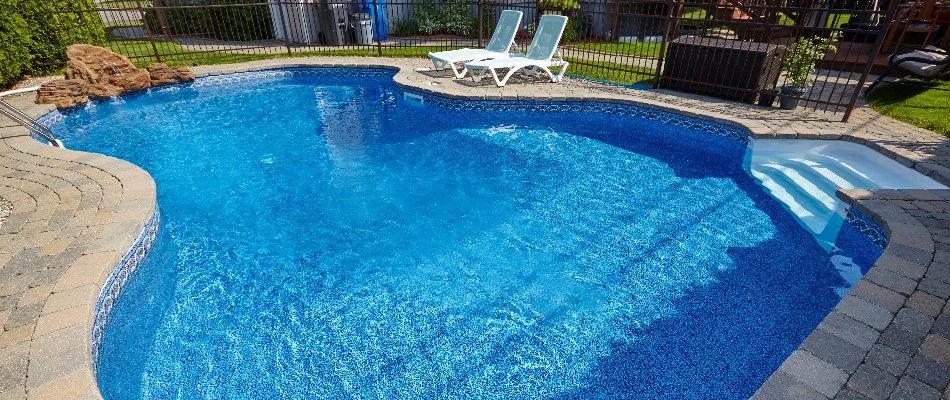 Vinyl pool in Bridgehampton, NY, with drop stairs and chairs.