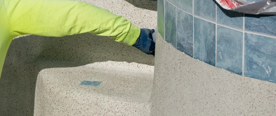 Worker resurfacing a pool in Bridgehampton, NY.