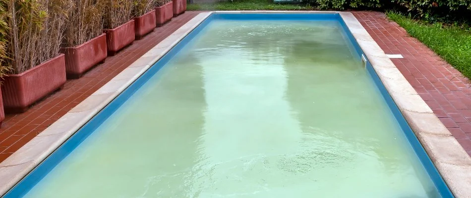 Cloudy pool on a property in Bridgehampton, NY.