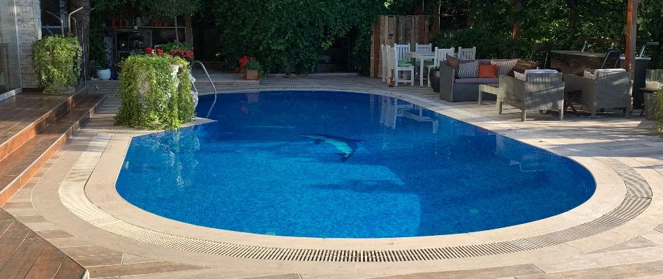 Patio furniture beside a pool in Springs, NY.