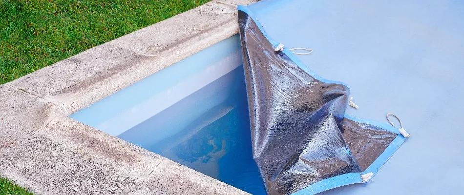 Pool cover on a pool with the corner open in Bridgehampton, NY.